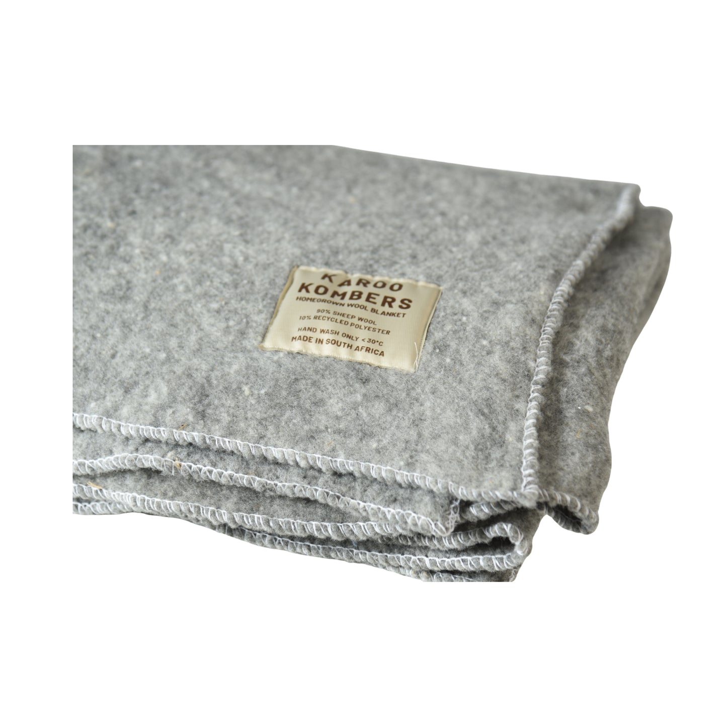 A folded gray felt blanket with a beige sewn-on label reading 'KAROO KOMBERS', shown on a plain white background.