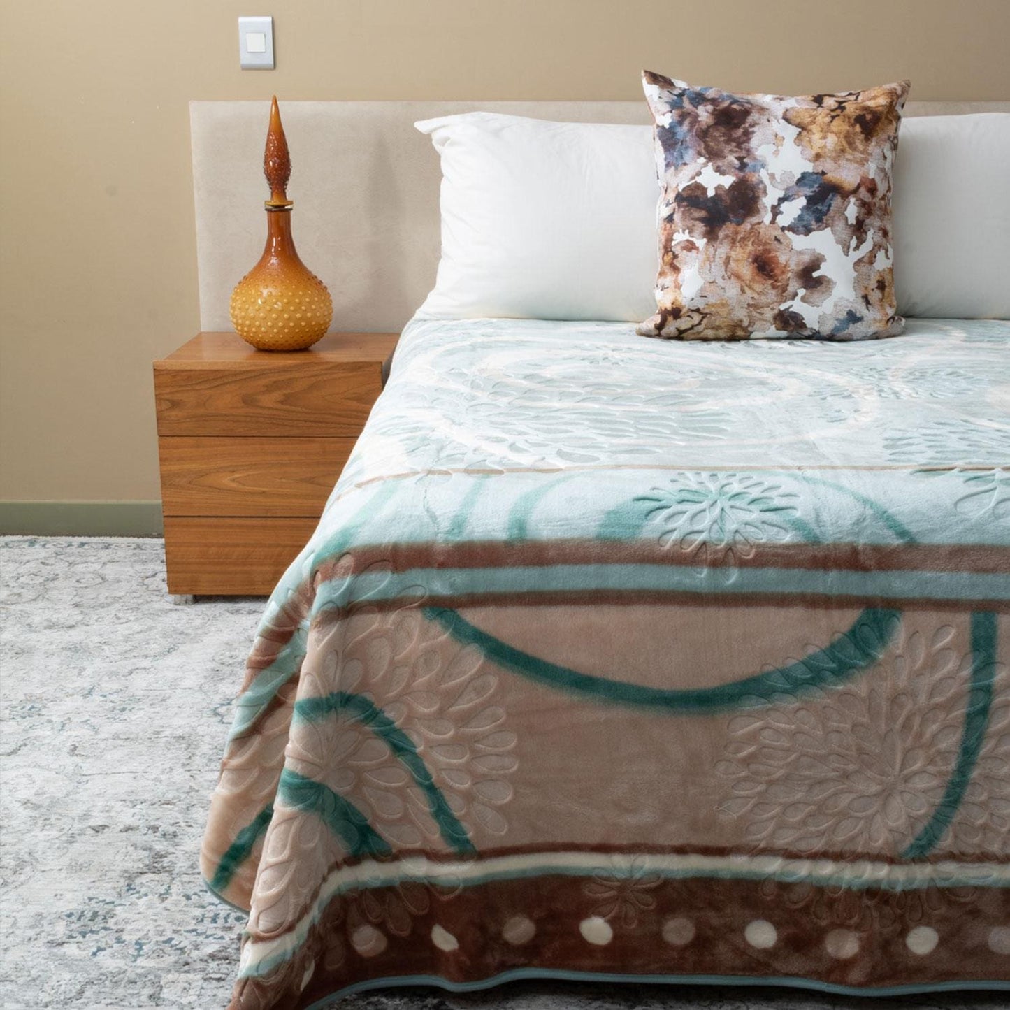 Folded Amigo mink blanket displayed on sofa