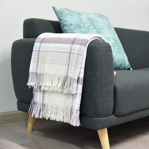 Warm Colorful Scotch Throw Blanket draped over the bed