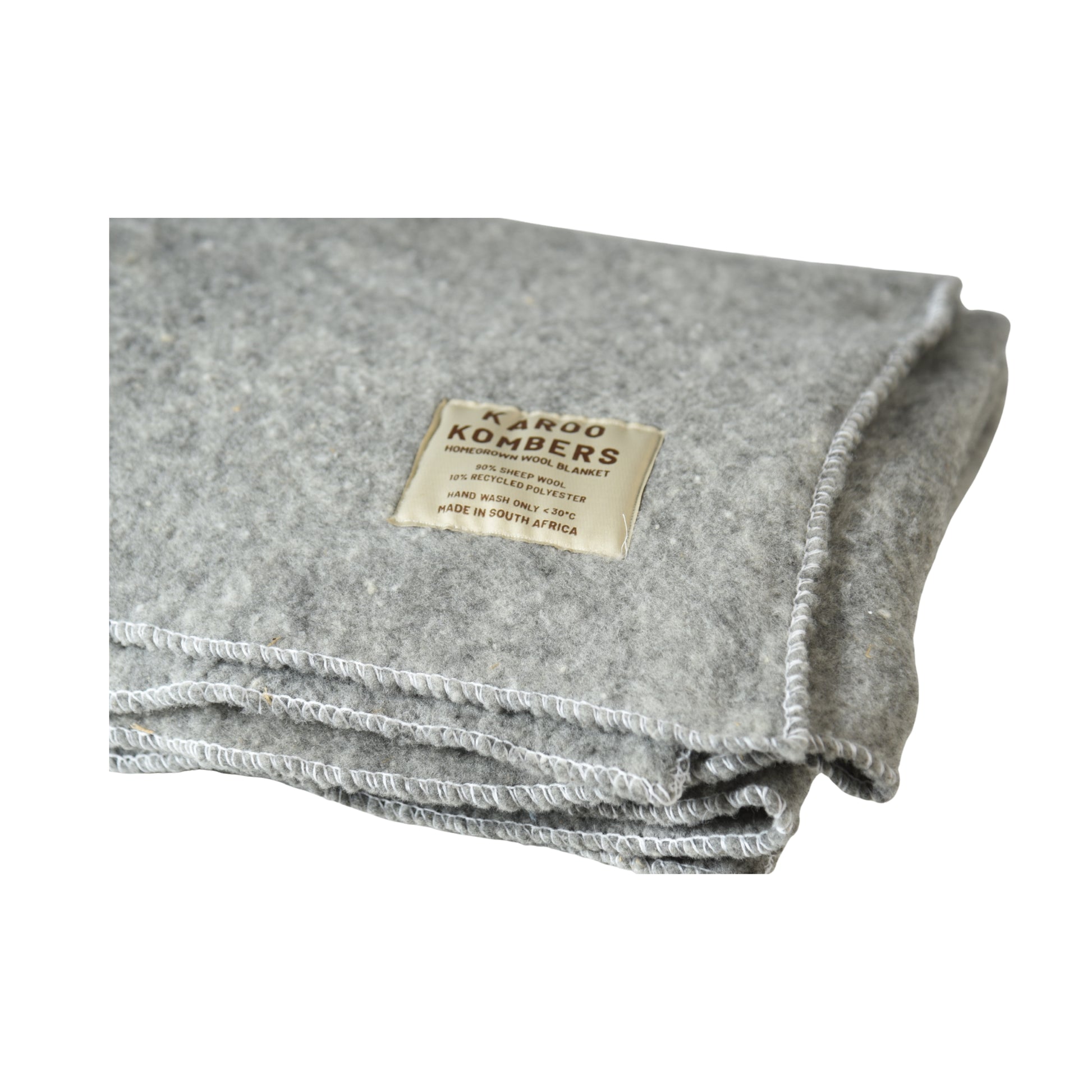 A folded gray felt blanket with a beige sewn-on label reading 'KAROO KOMBERS', shown on a plain white background.