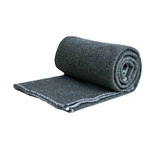 Rolled-up grey wool blanket on a white background