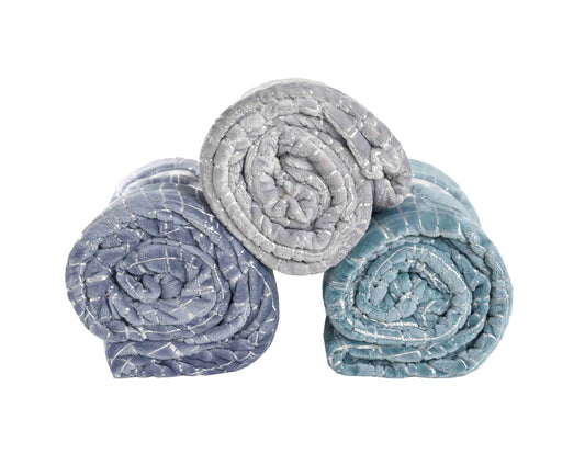 Cozy plush throw blanket in silver draped over a couch