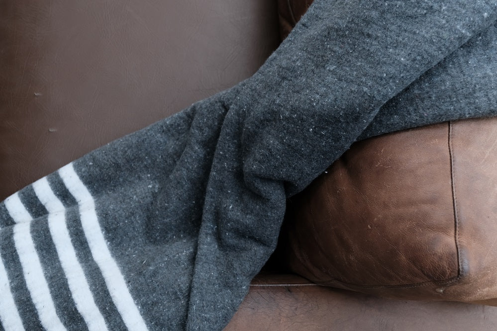 Close-up of Grey Donation Blanket showcasing soft acrylic and polycotton fabric
